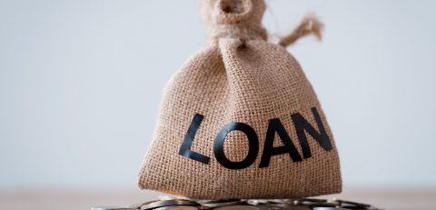 sackcloth money bag with loan inscription and metal coins isolated on grey